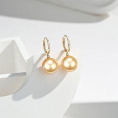 Golden South Sea Pearl DaisyEarrings Make your ears shine brighter than the stars with House Of Pearls’ Golden South Sea Pearl & Daisy Earrings. Crafted with solid gold pearls, these earrings will add the perfect touch of elegance to your everyday look. With their golden Hoops, these earrings will move and catch the light, adding a unique sparkle to your wardrobe. This popular earring design features AAA-AAAA quality. Material: 18k Gold with Golden South Sea Pearls Choose your pearl grade and pe Gold Pearl Earrings With Ear Wire For Fine Jewelry, Elegant Gold Beaded Pearl Earrings, Yellow Gold High Luster Drop Earrings, Yellow Gold Round Beads Earrings, Gold Pearl Earrings With Round Beads For Formal Occasions, Elegant Gold Plated Round Bead Earrings, Gold Pearl Bead Earrings For Formal Events, Elegant Gold Plated Earrings With Round Beads, Gold Round Pearl Earrings With High Luster