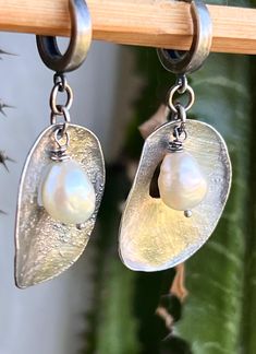 "Made with 925 silver sheet, molten to create an unique raw texture, then brush polished to a satin, brushed finish. Total drop is 1 3/4\". 3/4\" wide. The hoops are about 3/8\" diameter, or 10 mm . The light off white pearls have beautiful luster.  These 2 were salvaged a while ago from some other jewelry and I do not have that exact color anymore.  Will be shipped in a craft gift box." Artisan Silver Jewelry With Pearl Drop, Elegant Hand Cast Drop Earrings, Elegant Hand Cast Metal Earrings, Silver Hand Cast Dangle Earrings, Hand Cast Silver Dangle Earrings, Unique Silver Pearl Drop Earrings, Elegant Hand Cast Antique Silver Jewelry, Silver Hand Cast Drop Earrings, Hand Cast Silver Drop Earrings