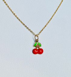 "A beautiful 14K solid yellow gold Red Cherry puffy charm / pendant with hand painted and baked enamel. It has a soldered ring to attach to a bracelet or a necklace. The small pendant measures 10mm (0.39\") tall with bail and without the soldered ring and 7.3mm (0.29\") wide. It can be used as a necklace pendant or a bracelet charm and would make a perfect gift. The pendant can be paired with a shiny 14K Yellow Gold 1.2mm cable link chain in either 16\" or 18\" length or with a 16\" 14K gold-pla Dainty Red Jewelry For Everyday, Handmade Yellow Gold Enamel Necklaces, Handmade Yellow Gold Enamel Necklace, Dainty Red Charm Necklace For Everyday, Green Vintage Charm Jewelry For Gift, Dainty Tiny Red Jewelry, Green Vintage Charm Jewelry Gift, Red Gold Plated Round Pendant Jewelry, Red Enamel Jewelry For Valentine's Day