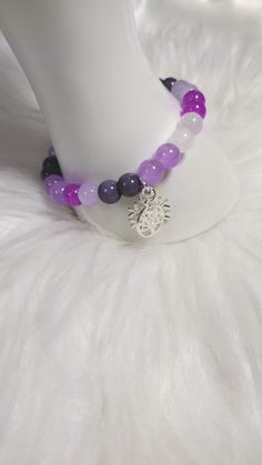 Amethyst Allure Bracelet  with Gemstone Crystal Beads, and Glass Beads, and Silver Charm. Each Charm is Random for Each Bracelet. Bohemian Purple Round Crystal Bracelet, Adjustable Amethyst Beads For Jewelry Making, Purple 8mm Beads Bracelet, Purple 8mm Bead Bracelet, Purple Round Beaded Bracelets For Meditation, Purple Round Beads Bracelet For Meditation, Purple Beaded Bracelets For Meditation, Purple Spiritual Charm Bracelet For Healing, Adjustable Purple Gemstone Beads Crystal Bracelet