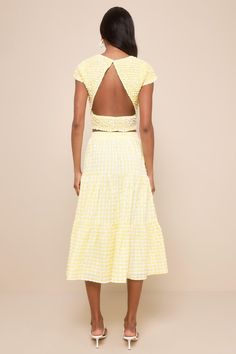 Be brilliant and beautiful all season long in the Lulus Cheerful Perfection Yellow Gingham Smocked Two-Piece Midi Dress! This two-piece dress boasts a bright yellow gingham print as it shapes a super stretchy, Y2K-inspired smocked top with a crew neckline, cap sleeves, and a cropped bodice with a cutout back design (and top button closure). Matching skirt features a smocked texture that falls from a high, elasticized waistband into a tiered, A-line midi skirt. Skirt has side seam pockets. Fit: T Fitted Cropped Dress For Day Out, Spring Summer Smocked Dress With Tiered Skirt, Summer Gingham Smocked Dress, Spring Gingham Smocked Dress For Picnic, Fitted Smocked Top For Summer Garden Party, Spring Smock Dresses For Picnic, Spring Picnic Gingham Smocked Dress, Chic Gingham Smocked Top For Summer, Summer Tiered Skirt Smocked Dress For Garden Party