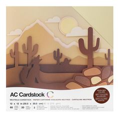 a cardboard cutout of desert scene with cactus and mountains