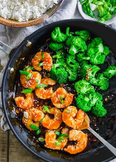 shrimp and broccoli stir fry in a skillet with white rice on the side