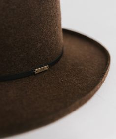 The Lennon is a true showstopper. Featuring a sculpted diamond crown paired with a crisp pencil roll brim, this hat is made for making an entrance. Elegant Everyday Hat Band With Flat Crown, Elegant Brown Hat Band For Everyday, Luxury High Crown Adjustable Hat Bands, Classic Brown Felt Hat With Flat Crown, Classic Fur Felt Hat Band With Flat Crown, Classic Boater Hat With Flat Crown, Classic Adjustable Top Hat With Flat Crown, Adjustable Top Hat With Structured Crown For Formal Occasions, Adjustable Top Hat With Structured Crown For Formal Events