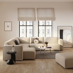 a living room filled with lots of furniture next to two large windows on top of a hard wood floor