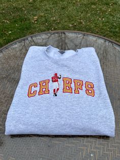 Chiefs Chris Jones Embroidered Crewneck Sweatshirt Crew Neck Top With Embroidered Text For College, Fall College Embroidered Tops, Embroidered Fall Tops For College, Embroidered Long Sleeve Tops For College, Fall College Embroidered T-shirt, Varsity Style Embroidered Tops For College, Varsity Long Sleeve T-shirt With Embroidered Logo, Varsity Crew Neck Top With Embroidered Text, Varsity Crew Neck Top With Letter Embroidery