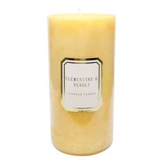 a yellow candle with a white label on it