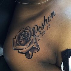 a woman's stomach with a rose tattoo on her chest and name written in cursive writing