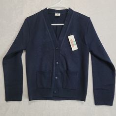 Claudia Uniform Escolares Navy Blue Cardigan Juniors Size 12 Nwt Button Front. Couldn't Find Any Info On This Company. I Believe It To Be Either A School Or Work Uniform Sweater/Cardigan. Heavy Duty Knit.. Garment Is New With Tags, In New Condition. Tag Says Size 12.. However Please See Photos For Measurements And Condition Thanks For Looking. @Neeko1979zy Blue V-neck Sweater With Button Closure, Blue V-neck Cardigan With Buttons, Blue Cotton Button-up Cardigan, Button-up Sweater With Buttons, Blue Tops With Button Cuffs For Winter, Blue Winter Tops With Button Cuffs, Winter Blue Tops With Button Cuffs, Long Sleeve Outerwear With Buttons For School, Classic Solid Single Breasted Cardigan