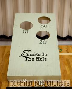 a close up of a cornhole game on a wooden floor with the words snake in the hole