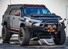 the front end of a gray four - doored suv parked in a parking lot