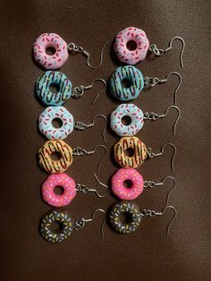 These amazing Donut earrings are handmade to order. The earrings are made from resin. These fun and quirky earrings will look stunning in anyone's collection. With beautiful colours to choose from.  They are a perfect small gift for yourself, family or friends. They are lead and nickel free making it safe to wear on a daily basis.  Choose blue, white, chocolate, baby pink, dark pink and orange  Come well presented on a suitable earring card, placed in a organised bag and then wrapped in decorative paper.  We aim to get the ready within a day and dispatched by the next working day.  Please note, orders made on a Friday will not be sent out until Monday. the earrings should not be worn in the shower, bath or while swimming Handmade Polymer Clay Earrings For Birthday, Sweet Handmade Polymer Clay Jewelry, Handmade Sweet Polymer Clay Jewelry, Sweet Handmade Earrings For Gift, Sweet Handmade Earrings As Gift, Cute Polymer Clay Dangle Earrings, Quirky Handmade Dangle Earrings, Playful Handmade Round Earrings, Cute Handmade Round Earrings