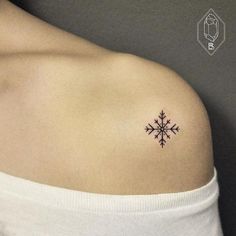 a snowflake tattoo on the left shoulder