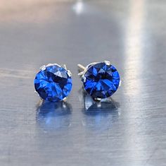 Fast First Class Shipping. Blue spinel was tested on one of the most accurate and reliable gem tester machines. And come from a reliable source. All my gemstone jewelry comes in nicely wrapped, so they are ready to be given as gifts! You will love these sparking and calming blue spinel studs. They shine and glisten almost like a diamond in the sunlight. Blue Spinel helps with mental focus and nervous energy, It will help complete a task until the end. Helps maintain progress. Helps purify negati Blue Birthstone Earrings For Formal Occasions, Formal Blue Birthstone Earrings, Classic Blue Round Earrings, Blue Earrings With Prong Setting For Anniversary, Blue Round Lab-created Sapphire Earrings, Blue Round Sapphire Earrings, Blue Lab-created Sapphire Jewelry With Diamond Cut, Blue Diamond-cut Lab-created Sapphire Jewelry, Sapphire Birthstone Earrings For Formal Occasions