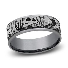 a wedding band with black and white fish in the ocean on an 18k white gold ring