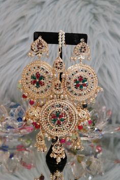 Handcrafted with love to give a real traditional look for this set beautifully studded with jadau stones gives a royal look. Includes: Earrings and Tikka Temple Jewelry Sets With Matching Earrings, Multicolor Chandbali Bridal Earrings With Intricate Design, Multicolor Kundan Bridal Earrings With Intricate Design, Multicolor Intricate Chandbali Bridal Earrings, Multicolor Bridal Earrings With Intricate Design For Diwali, Multicolor Temple Jewelry Bridal Earrings With Intricate Design, Multicolor Intricate Bridal Earrings For Diwali, Multicolor Kundan Chandbalis With Intricate Design, Multicolor Bollywood Bridal Earrings With Intricate Design