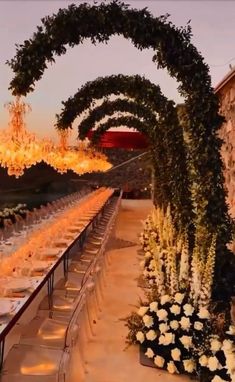 an outdoor dining area with chandeliers and tables set up for a formal function