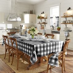 a dining room table is set with black and white checkered cloths on it