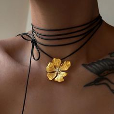 Introducing our exquisite Stainless Steel Flower Choker Necklace, a stunning blend of elegance and versatility. Crafted with precision, this intricately designed flower pendant boasts 18K gold plating, adding a touch of luxury to any ensemble. The centerpiece features a sparkling zircon gemstone, radiating brilliance with every movement. Designed for comfort and style, the adjustable black rope allows for a customizable fit, making it perfect for any occasion, whether it's a casual outing or a g Flower Choker Necklace, Zircon Gemstone, Necklace With Pendant, Steel Flowers, Flower Choker, Black Rope, Flower Pendant Necklace, Hip Hop Jewelry, Girls Necklaces