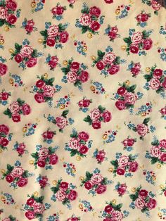 the fabric has pink and blue flowers on it