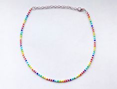 This rainbow beaded necklace is made with dainty, colorful glass seed beads It comes in 4 different sizes (14, 16, 18, and 20 inches), and every necklace from my shop also comes with additional extender chain, making it easily adjustable. If you are looking for a light rainbow and white necklace, this necklace is perfect for you! It makes a great gift for a friend, family member, or even yourself! This necklace is also a great way to celebrate pride month during June and all year round! Rainbow Beaded Necklace, Summer Choker, Rainbow Choker, Pride Necklace, Diy Friendship Bracelets Tutorial, White Choker, Pearl Charm Necklace, Friendship Bracelets Tutorial, Rainbow Necklace