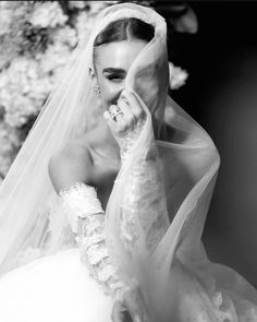 black and white photograph of a woman wearing a wedding dress with veil on her head