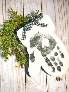 a hand and foot print on a wooden board