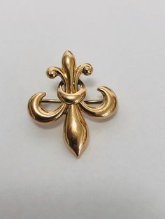 A classic image of the Victorian era ,this beautiful pin/ brooch is a Fleur De Lis in 14k Gold can be worn as a pendant by threading a chain or ribbon through by the small loop at the topor it can be worn as a classic brooch. Condition: Pre-Owned.--Good vintage condition.. Art Deco Yellow Gold Brooches For Formal Occasions, Yellow Gold Art Deco Brooches For Formal Wear, Art Deco Yellow Gold Formal Brooches, Formal Art Deco Yellow Gold Brooches, Art Deco Yellow Gold Collectible Brooches, Elegant Antique Gold Collectible Jewelry, Victorian Yellow Gold Jewelry With Screw Back, Formal Antique Gold Jewelry Stamped 14k, Victorian Gold Brooch Jewelry