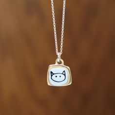 This teeny tiny love kitty necklace is adorable. It's very dainty and elegant with its velvety gold finish. It would make a great gift for the cat fanatic in your life.  Each piece gets 3 layers of kiln-fired enamel on top of cast sterling silver. I then apply the custom screen print made from my drawings straight from my sketchbook. Finally, the design is dipped in gold. Durable, adorable and unique!  Each pendant comes on a high quality gold filled chain, choose your length from the drop down Cute Gold Jewelry With Cat Design, Everyday Cute Nickel-free Charm Necklaces, Dainty Cat Design Necklace Gift, Cute Gold Necklace With Cat Design, Gold Cat Design Charm Necklace As Gift, Gold Charm Necklace With Cat Design As Gift, Gold Charm Necklace With Cat Design For Gift, Cute Cat Print Jewelry Gift, Gold Sterling Silver Necklace With Cat Design