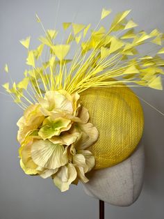 This beautiful yellow sinamay fascinator is a statement piece. Beautiful yellow feathers & hydrangea petals are positioned on a yellow sinamay fascinator. The fascinator is secured in plastic with an elastic headband. This Fascinator is stunning, perfect for all summer events, weddings and races. Brand New. If you need your item by a certain date please let me know. Made in the UK. All items are handmade and may differ very slightly to picture shown.  Custom orders are welcome. Many more items are available in our Shop. Returns Please notify us within 3 days of receiving your item if you intend to return it. We allow 7 days from the date of receipt of the headpiece to return it to us, our returns requirements are that it is returned properly packaged to prevent damage in the post, it is un Sunflower Fascinator, Hydrangea Yellow, High Tea Outfit, Tea Outfit, Yellow Fascinator, Hydrangea Petals, Fascinator Wedding, Sinamay Fascinator, Yellow Feathers