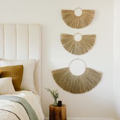 a bedroom with three circular mirrors hanging on the wall above the headboard and bed