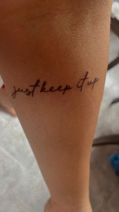 a woman's foot with the words just keep up written on her left leg