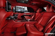 the interior of a car with red leather seats