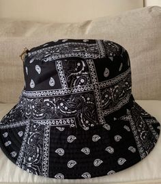 Bucket Hats: White bandana print reversible to solid black Black bandana print reversible to solid black Bandana Bucket Hat, Reversible Black Bucket Hat, Black Reversible Hat For Streetwear, Black Reversible Bucket Hat, Casual Black Bandana For Outdoor, Casual Black Reversible Bucket Hat, Casual Black Bucket Hat For Festivals, Black Bandana For Summer Beach, Black Bandana For Summer Beach Outings