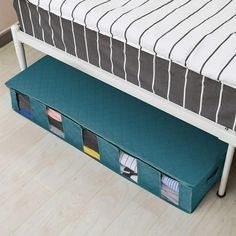 a bed with drawers underneath it on the floor