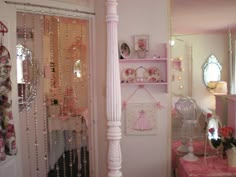 a bedroom with pink furniture and accessories in it