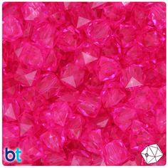 bright pink crystals are scattered on top of each other in this image, the color is very