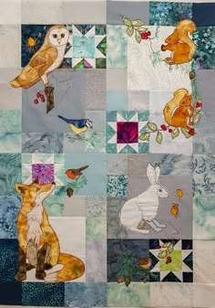 a patchwork quilt with animals and birds on it