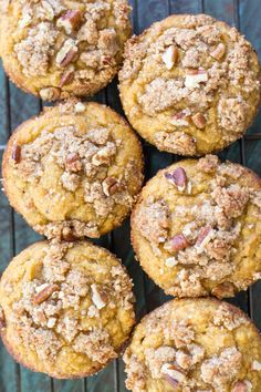 freshly baked muffins on a cooling rack with pecans in the foreground