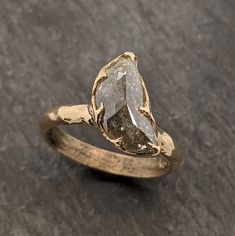 a yellow gold ring with a rough diamond