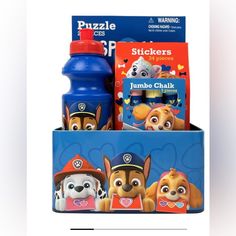 two children's books and a water bottle in a blue box with paw patrol characters on it