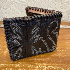 "I've taken a vintage black leather cowboy boot and turned it into a one of a kind wallet. Insert is genuine leather. Places for ID,credit cards, and cash. Hand stitched and crafted. Vintage and handmade items will not be perfect but I try to capture any flaws in photos. Would make a great gift for the cowboy or cowgirl in your life! Length open: 9 1/2\" Length folded: 5\" Width: 4\"" Black Hand Tooled Bifold Wallet, Black Leather Wallet Hand-stitched, Hand-stitched Black Leather Wallet, Vintage Black Trifold Wallet For Everyday Use, Hand-stitched Black Rectangular Wallet, Black Hand-stitched Rectangular Wallet, Vintage Black Rectangular Trifold Wallet, Black Rectangular Hand-stitched Wallets, Western Style Leather Rectangular Wallet