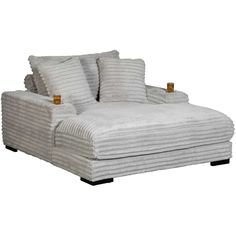 a white chaise lounge chair with pillows on the back and arms, stacked together