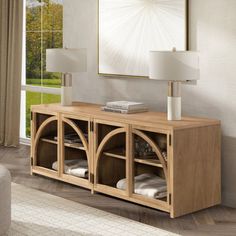 a living room scene with focus on the sideboard and large window in the background