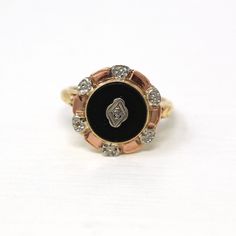 Pretty vintage circa 1940s era retro 10k yellow gold genuine onyx ring! This stylish statement ring features a round black onyx gemstone that is bezel set and adorned with a plaque and sparkling diamond at its center. The black gem is surrounded by a halo of rose and white toned floral details that accent the piece nicely. The band is gently tapered with milgrain details on the shoulders. A classic piece of fine retro jewelry! *Sale - price reduced from $425 USD to $410 USD.  ERA - Circa 1940s - Retro  METAL / MATERIAL - 10k yellow gold with rose and white accents, genuine black onyx, genuine diamond (approx. .01 ct).  MARKINGS / HISTORY - Inside of band is marked with '10K' CONDITION - Good vintage condition. Yellow gold metal has been professionally polished & cleaned. Little age appropr Vintage Yellow Gold Signet Ring With Gemstone, Vintage Gold Cluster Ring With Gemstones, Victorian Black Enamel Rings For Anniversary, Victorian Black Enamel Anniversary Rings, Antique Round Enamel Ring, Vintage Gold Enamel Ring Stamped 14k, Vintage Gold Round Cluster Ring, Vintage Black Enamel Ring For Anniversary, Vintage 14k Gold Cluster Ring Hallmarked