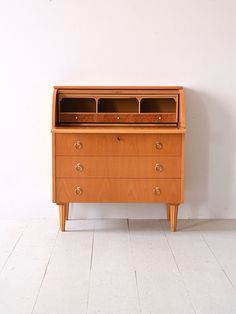 an old wooden dresser with two drawers on one side and a drawer on the other