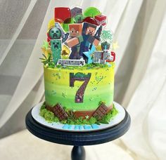 a birthday cake with the number seven made out of legos and decorations on it