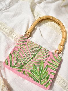 Beaded Palm Leaf Bag with Bamboo Handles  | Confête Summer Pink Beaded Bag, Summer Pink Beaded Shoulder Bag, Elegant Pink Vacation Bag, Pink Rectangular Shoulder Bag With Bamboo Handle, Pink Bag With Top Handle And Bamboo Detail, Green Beaded Bag For Summer, Summer Green Beaded Bag, Pink Top Handle Bag With Bamboo Handle, Pink Vacation Bag With Bamboo Handle