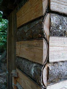 logs stacked on top of each other with the words coal idea, this guy built a shed using wooden sides