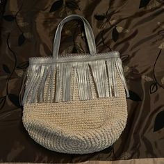 Leather Silver Metallic Fringe With Snap Closure. Fringe Bucket Bag For Shopping, Chic Beach Bag With Fringe, Chic Straw Bag With Fringe, Chic Straw Bags With Fringe, Chic Natural Color Bags With Fringe, Everyday Straw Bag With Fringe, Everyday Straw Bags With Fringe, Straw Tote Bag With Fringe, Raffia Palm